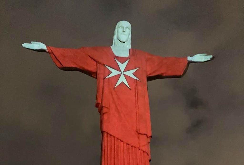 Christ the Redeemer in Rio de Janeiro illuminated with the flag of the Order of Malta